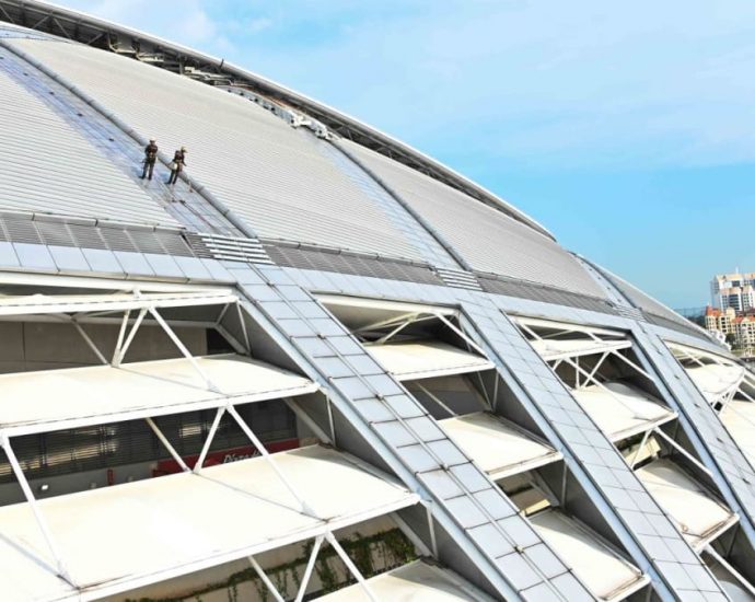 What does it take to clean the world’s largest dome? Men suspended by ropes