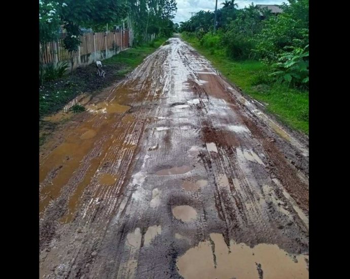 Village forced to rely on muddy, potholed road for decades