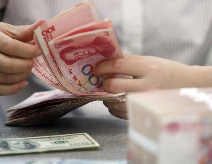 China's yuan weakens past key 7/dlr mark for first time in 2 years