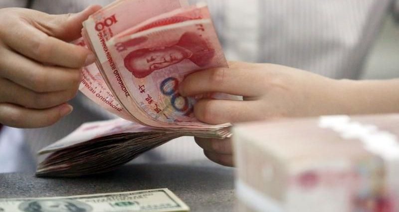 China's yuan weakens past key 7/dlr mark for first time in 2 years