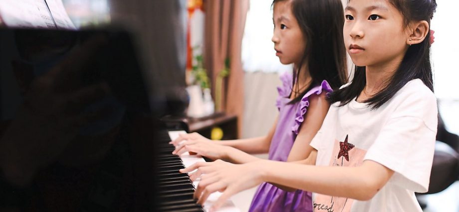 7YO twins from Puchong pass piano Grade 8, enter Malaysia Book Of Records