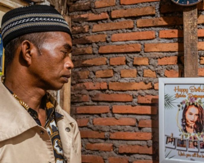 At Indonesia cemetery, father kisses daughter killed in stadium crush goodbye