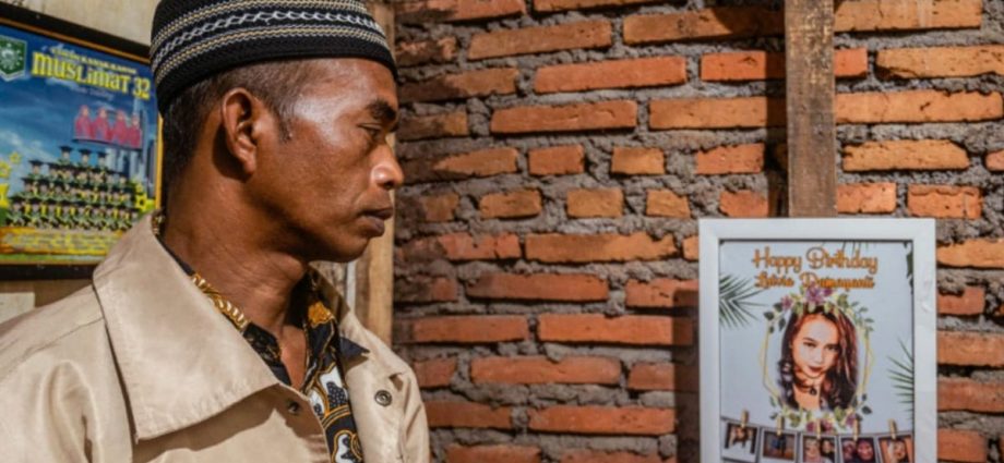 At Indonesia cemetery, father kisses daughter killed in stadium crush goodbye