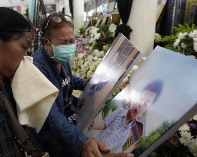 Grieving families pray at Thai temple for slain nursery victims