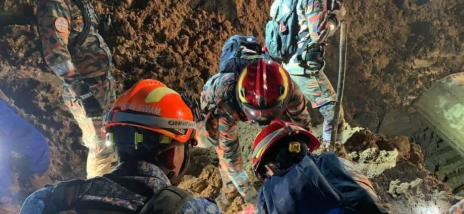 Body of man hugging dog recovered as Malaysia landslide death toll rises to 26
