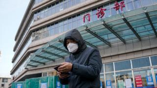 China Covid: Hospitals under strain in wave of infections
