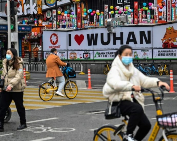 Bustling Wuhan markets celebrate Chinese New Year but grief remains