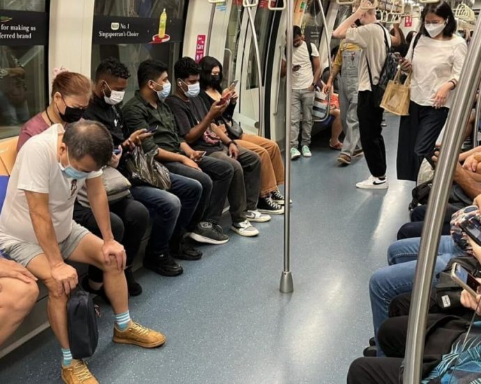 Singapore commuters keep masks on despite discarded COVID-19 public transport rule