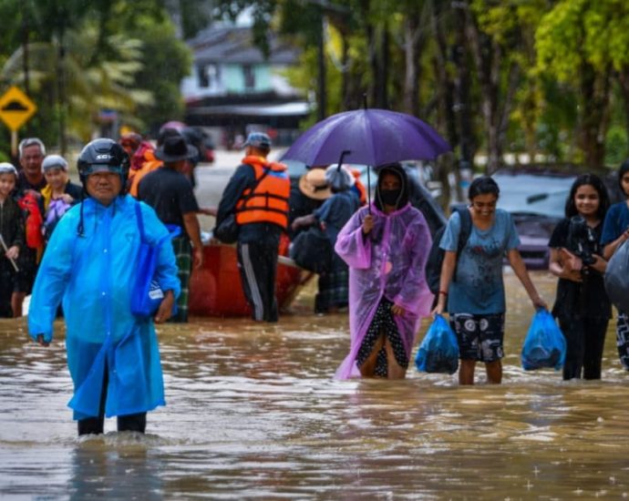 At least four dead, tens of thousands evacuated in Malaysia floods