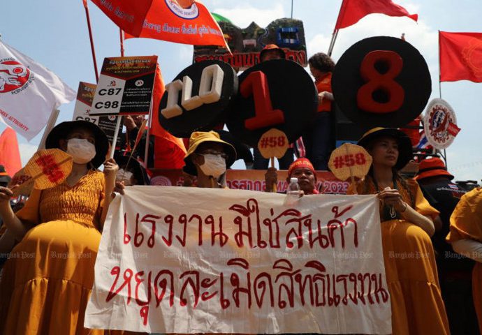 Workers march to demand higher pay