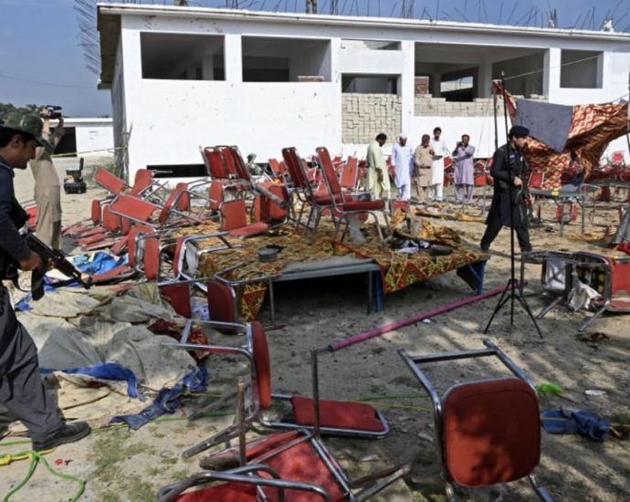 Pakistan police comb bomb site after deadly blast