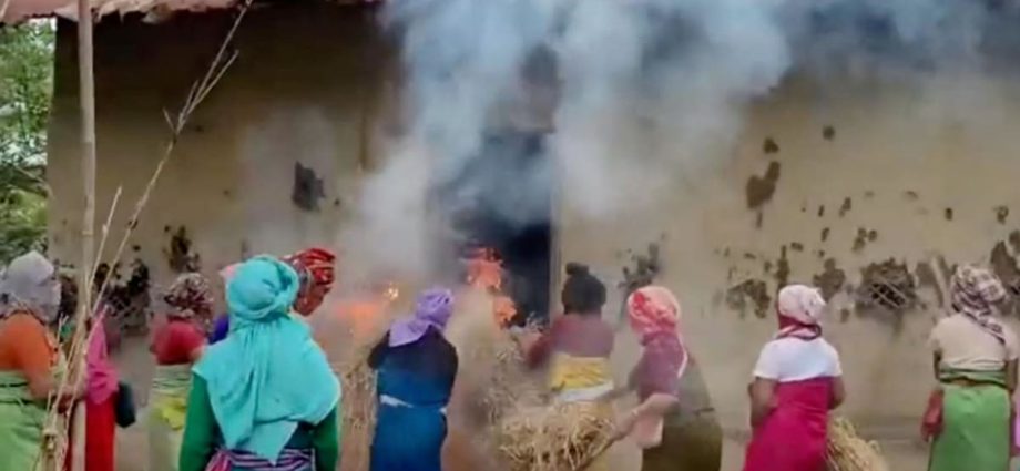 Women burn down houses of two accused over India naked women video