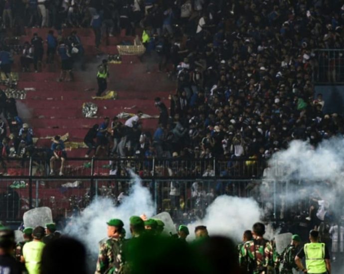 Indonesia court overturns acquittal of two policemen over stadium deaths