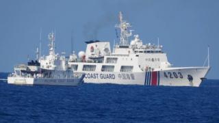 South China Sea: Philippines says Beijing installed floating barrier in contested area