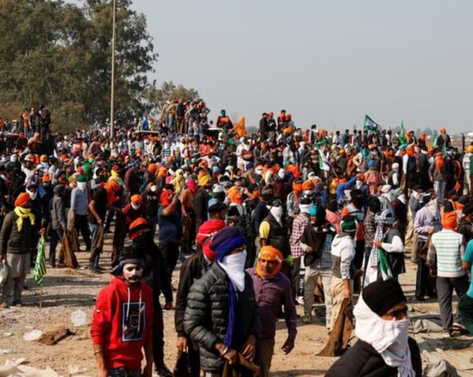 Indian security forces fire tear gas at protesting farmers on drive to Delhi