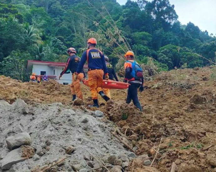 Rescuers use bare hands and shovels to search for landslide survivors in Philippines