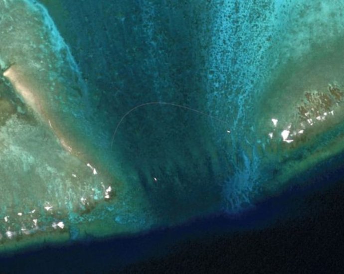 Satellite images reveal floating barrier at mouth of disputed atoll in South China Sea