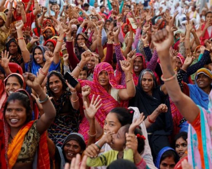 With handouts, piped water and cooking gas, India's Modi woos women voters