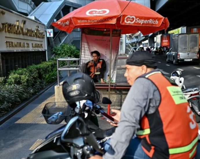 ‘Have to be outside’: Thai delivery riders swelter in heatwave