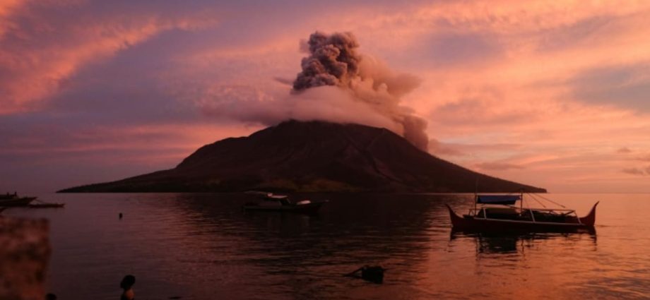 Indonesia lowers Mount Ruang volcano alert level, reopens nearby airport