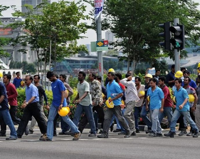 High fees, unlicensed agents: The price migrant workers pay to work in Singapore