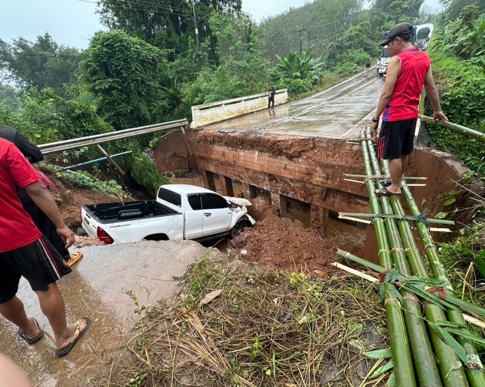 Truck plunges off washed-out bridge during heavy rain