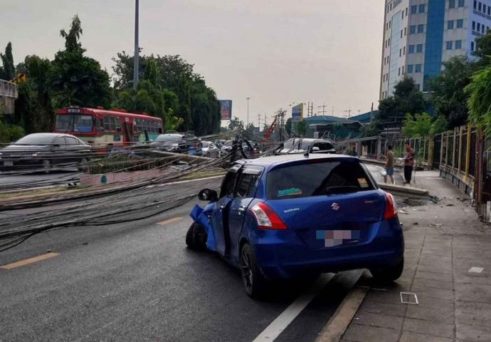 Car topples 12 Bangkok power poles, causes blackout